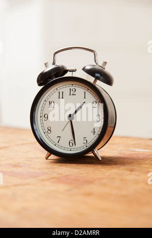 Alarm clock on wooden table Stock Photo