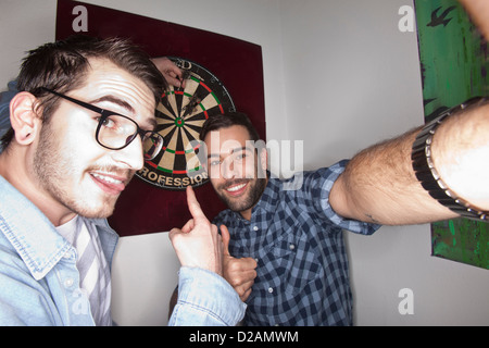 Smiling men taking picture together Stock Photo