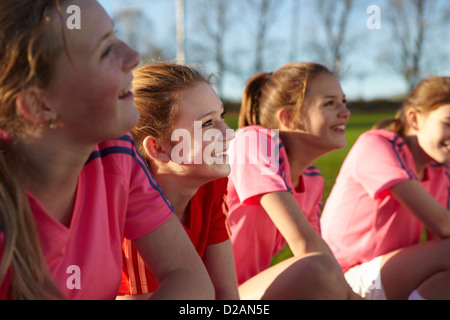 Football team smiling together in field Stock Photo