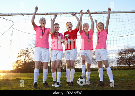Football team cheering in field Stock Photo