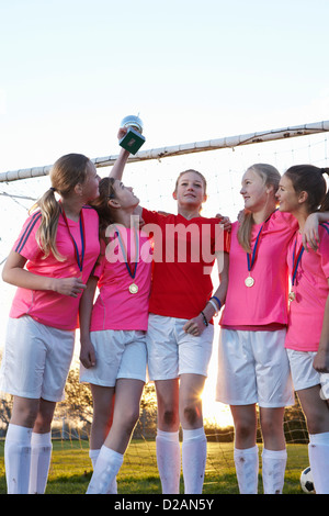 Football team cheering in field Stock Photo