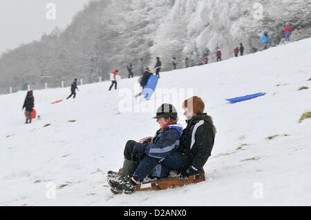 Cardiff, UK. Friday 18th January 2013. Two young boys make the best of the snow on their sledge in Cardiff, UK. All Schools  in Cardiff where closed today after heavy snow fall overnight that is to continue into the weekend. The UK Met Office has issued a severe weather warning for South East Wales. Stock Photo