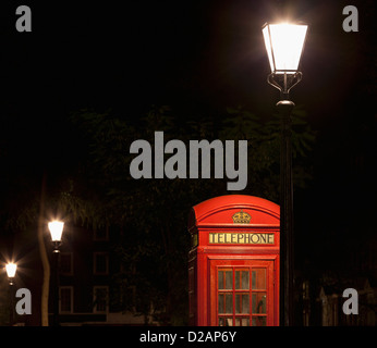 Red telephone box on city street Stock Photo