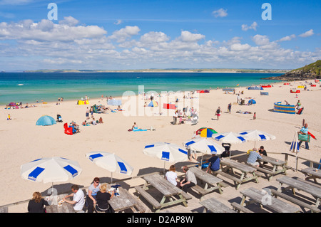 holidaymakers sunbathing and enjoying themselves on Porthmeor beach and cafe  St Ives Cornwall England UK GB EU Europe Stock Photo