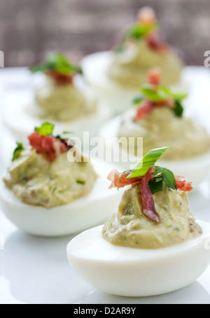 Fancy green deviled egg appetizer with garnish Stock Photo