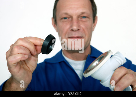 Plumber with two replacement fixtures Stock Photo