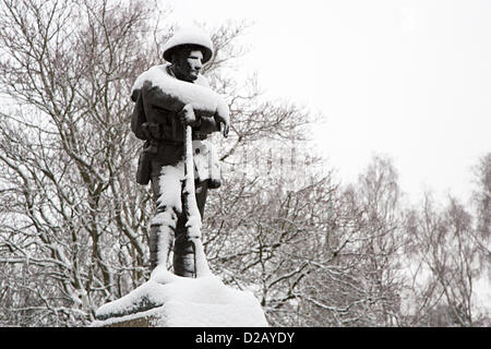 Snow picks out the face of a solder on the First World War memorial in Abergavenny, Wales, UK Stock Photo