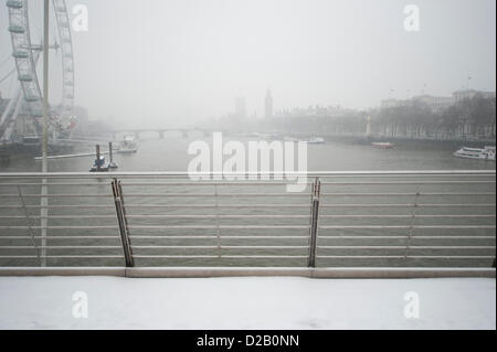 London, UK. 18th Jan, 2013. Snow falling in Central London on Friday morning in dull conditions on the river Thames seen from the Golden Jubilee Footbridge. An amber severe weather warning was announced for London and the SE of England. Credit: Malcolm Park/Alamy Live News Stock Photo
