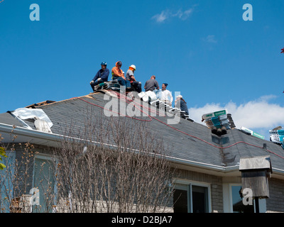Roofing crew having a lunch break whilst putting on new roof Ontario Canada Stock Photo