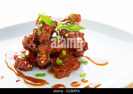Chinese spare ribs on a plate isolated on white. Stock Photo