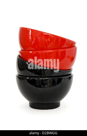 Zigzag stack of two red and two black porcelain bowls isolated Stock Photo