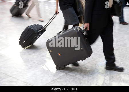 Cologne, Germany, Manager, man and woman are in a hurry with his luggage on the way Stock Photo