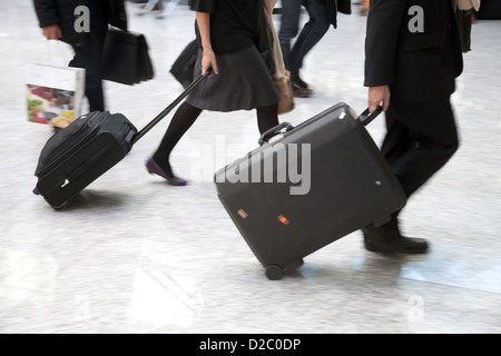 Cologne, Germany, Manager, man and woman are in a hurry with his luggage on the way Stock Photo