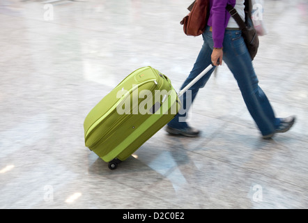 Cologne, Germany, Manager, Youth woman is traveling with his luggage in a hurry Stock Photo