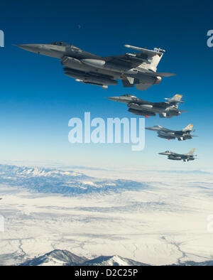 US Air Force pilots from the 421st Fighter Squadron maneuver along side a KC-135 refueling aircraft while waiting to receive fuel January 18, 2013 during a training mission in Utah. Stock Photo