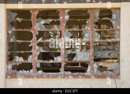 A window with the glass broken out of it that is in an abandoned building on Fort Ord, a closed military base. Stock Photo