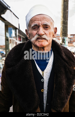 portrait of old Kosovan man with white mustache and traditional cap in Pristina bazaar, Kosovo Stock Photo