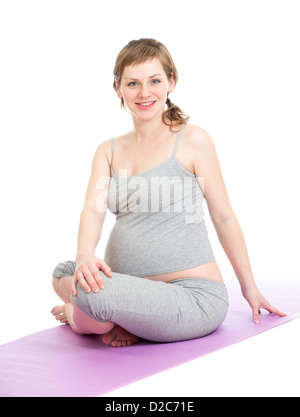 Pregnant woman doing gymnastic exercises isolated on white Stock Photo