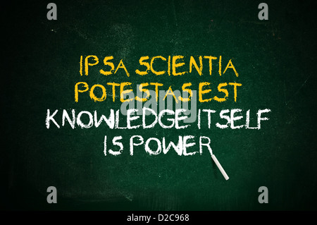 Knowledge is power. Latin quote handwritten with chalk on a green school board. Stock Photo