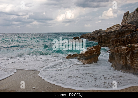 Waves breaking on rocky beach Stock Photo