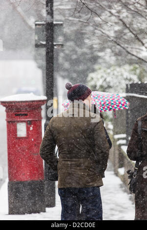 London, UK, Sunday 20th Janury 2013. A pedestrian walks along Camberwell New Road, Camberwell, South London. This is the third day of snow in the capital and forecasters predict more for later with temperatures around freezing. Alamy Live News. Stock Photo