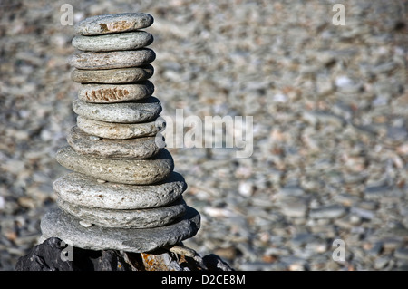 Stacked pebbles on pebble beach Stock Photo