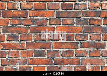 Old weathered red brick wall as background Stock Photo