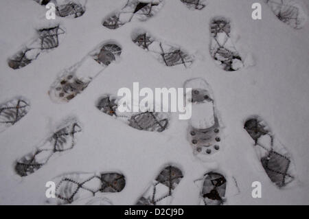 London, UK, Sunday 20th January 2013. Footprints in the fresh snow in London.  2013 gets off to a cold start as freezing weather hits the UK.  Over the weekend of the 19th January, over 10 inches of snow fell in some areas of the UK with more falling on the Sunday and more expected during the following week. Stock Photo