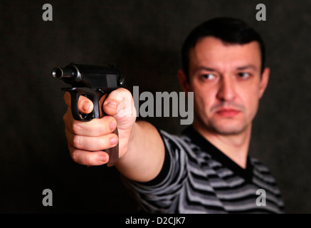 The man with a pistol on a background Stock Photo