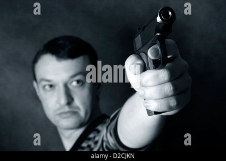 The man with a pistol on a background Stock Photo