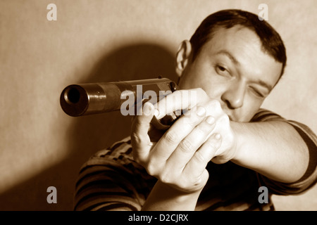 The man with a pistol on a background Stock Photo