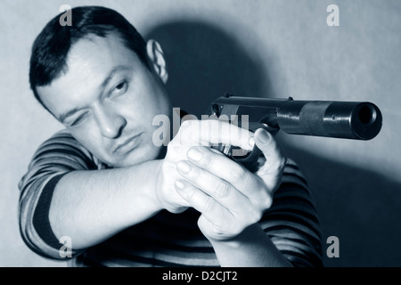 The man with a pistol on a background Stock Photo