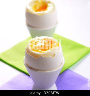 Soft-boiled eggs in coloured egg cups Stock Photo - Alamy