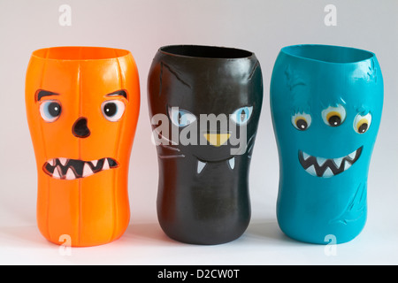 scary halloween faces on plastic beakers isolated on white background Stock Photo