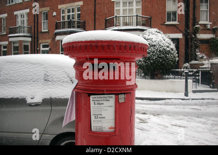 London postbox in winter snow Stock Photo