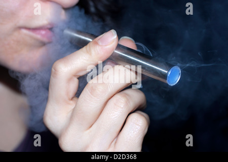 Woman smoking electronic cigarette closeup Stock Photo