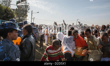 ADDIS ABABA, ETHIOPIA– JANUARY 19: Holy water sprayed on thousands of people attending Timket celebrations of Epiphany, commemorating the baptism of Jesus in the river of Jordan, on January 19, 2013 in Addis Ababa. Stock Photo