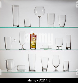 One glass filled with bubble tea placed amongst a collection of empty drinking glasses Stock Photo