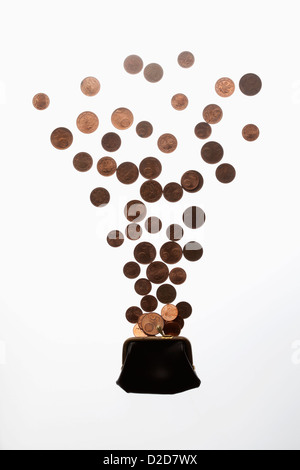 Coins falling into a purse Stock Photo - Alamy