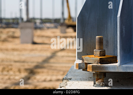 Large nut and bolt connected to beam in construction site Stock Photo