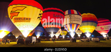 Bristol, UK - August 13, 2011: A row of Hot Air Balloons glow at night for the Bristol Balloon Fiesta at Ashton Court. Stock Photo