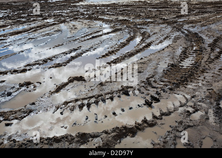 Deep tire tracks imprinted on a muddy terrain Stock Photo