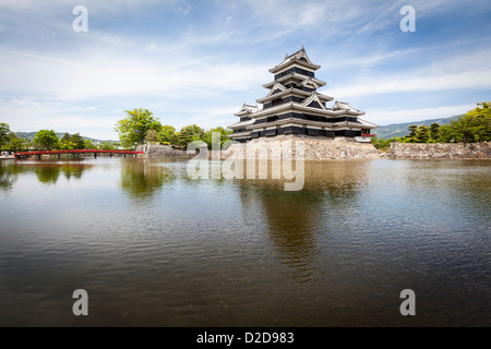 Matsumoto, Japan - May 13, 2012: Wide angle view of Matsumoto castle with it's black and white wooden keep and stone block walls Stock Photo