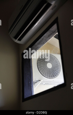 An electric fan seen through a window, low angle view Stock Photo
