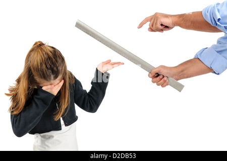 Young girl being physically punished by teacher with a ruler Stock Photo