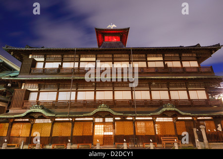 Dogo Onsen and the cityscape of Matsuyama, Japan. Dogo Onsen is one of the most famous hot spring bath houses in all of Japan. Stock Photo