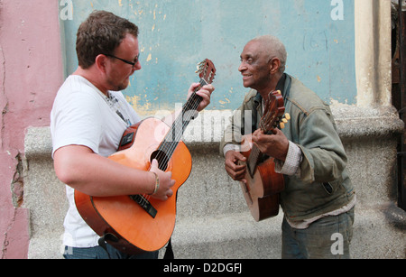 2 men playing the guitar in the street, Havana, Cuba Stock Photo