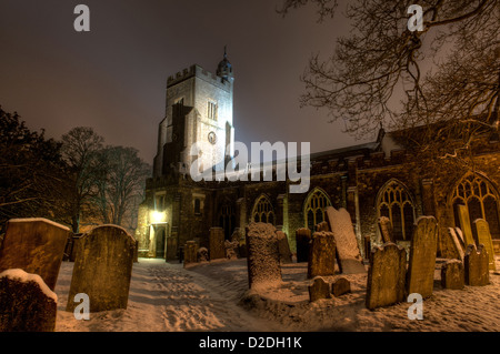 Snow set scene of St Nicholas Parish Church C of E cofe graveyard at night isolated and bleak bitterly cold settled snow Stock Photo