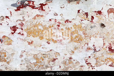 The naturally peeling paint and plaster on a wall in the Greek island of Hydra Stock Photo