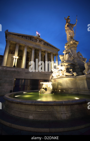 The fountain of Athena and the grand Austrian Parliament in Vienna, at twilight Stock Photo